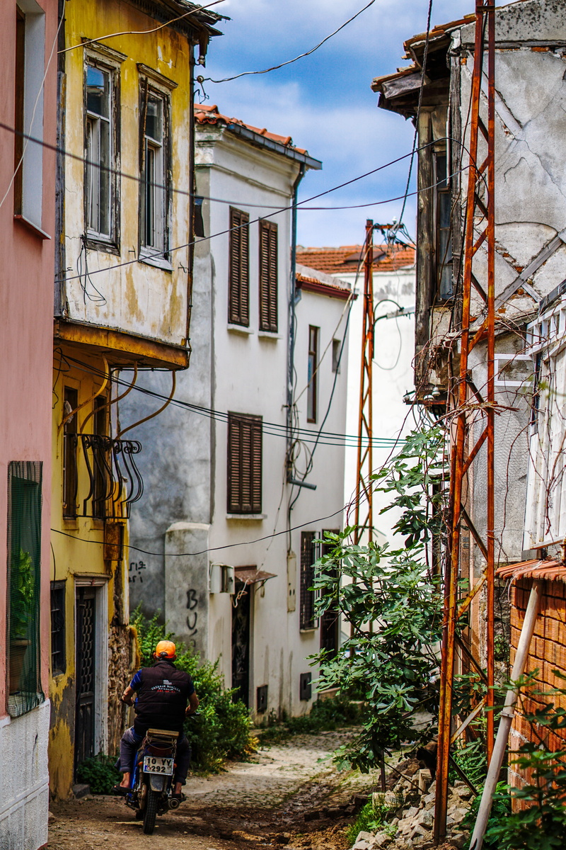 transport, color, street, daytime, decay, man, structure, plant, men, alley, footpath, transportation, building exterior, motorcycle, window, view, near