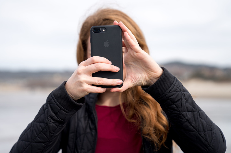 holding, hairstyle, portable information device, communication, photo, outdoors, using phone, day, warm clothing, hair, telephone, real people, iphone