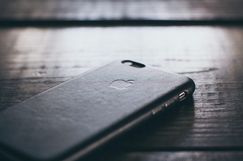 wood - material, close-up, leather, two objects, metal, table, communication, still life, no people, wireless technology, phone case, extreme close-up