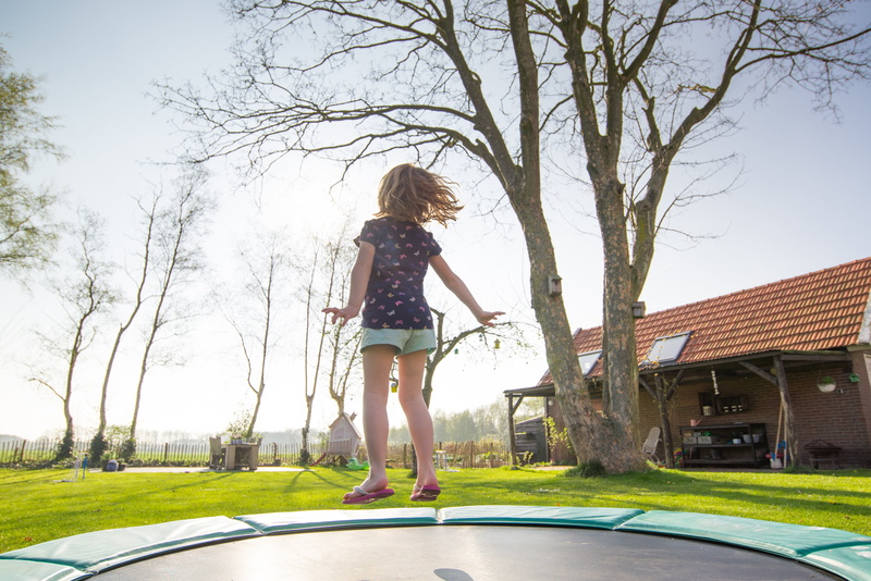 house, childhood, outdoor, sport, day, girls, playful, hairstyle, blond hair, one person, little, active, exercise, jump, cute, women, plant, full length