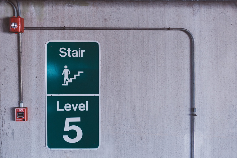 bathroom, sign, entrance, fire alarm, wall - building feature, stair, close-up, communication, no people, guidance, green, safety, white, symbol, text