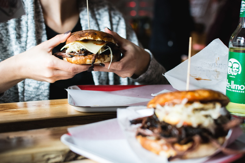 meal, ready-to-eat, eating, one person, take out food, indulgence, hand, hamburger, unhealthy Eating, holding, fast Food, table, real people, food And Drink
