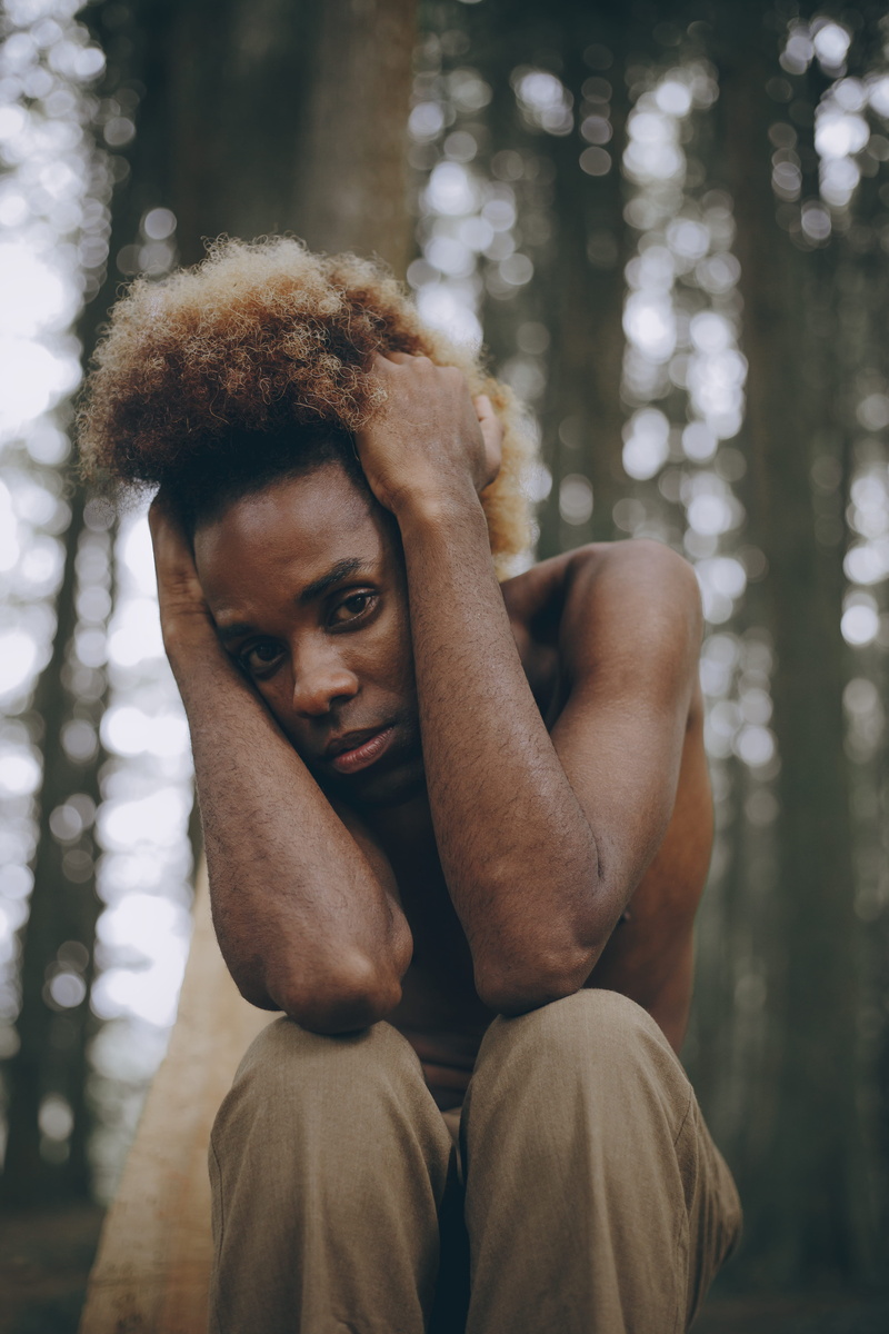 portrait, person, facial expression, hairstyle, adult, forest, sitting, holding, real people, photo, pose, posture, photoshoot, tree, one person, three quarter length