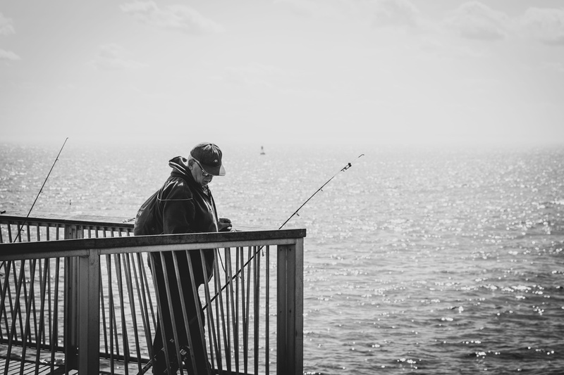 old man, leisure activities, fishing, sky, the fisherman, helmet, outdoors, fishing rod, man, black and white photography, animal, day, lifestyles, near