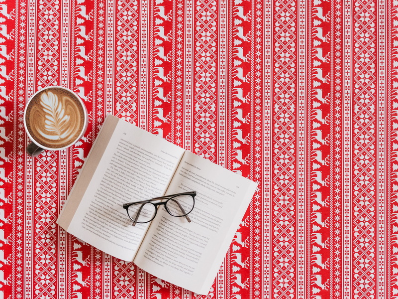 alphabet, women, publication, accessories, reading, white bedding, food and drink, rug, text, drink, no people, coffee, eyeglasses, still life, winter
