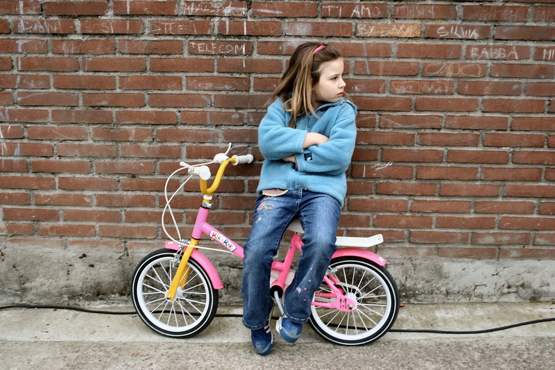 outdoors, wall, wall - building feature, parents, teenager, sitting, outdoor, road, casual clothing, adolescence, architecture, female, full length, race