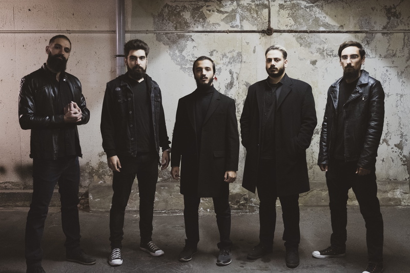 looking at camera, bassist, hands in pockets, bass, drums, wall - building feature, violin, real people, portrait, guitar, nomad, done, drummer, no, albums