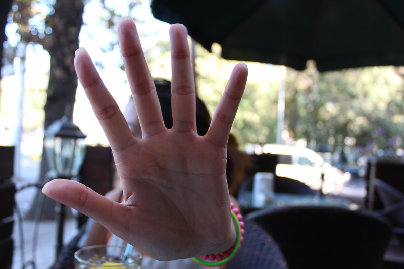 focus on foreground, human finger, danger, human, adult, leisure activity, real people, human hand, signal, obscured face, warning, body part, outdoors