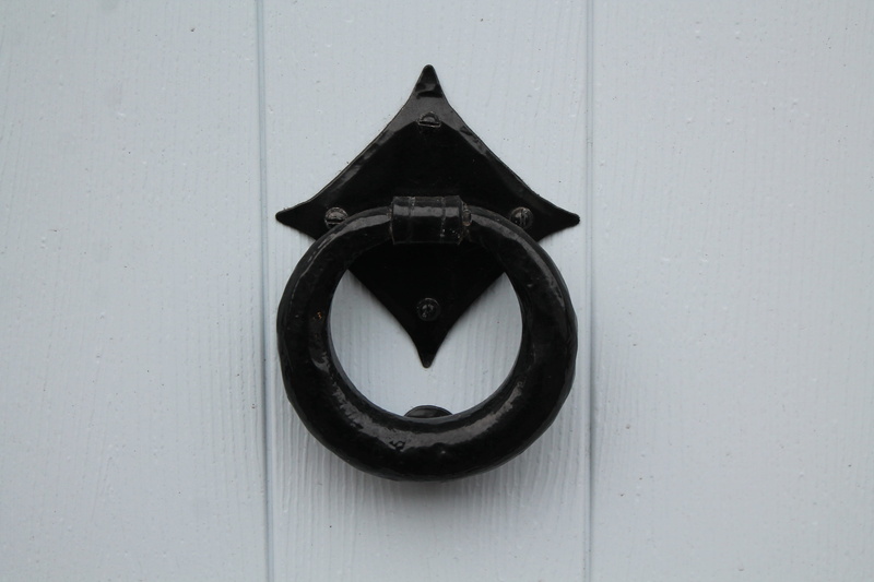 text, wall - building feature, no people, built structure, symbol, door, horseshoe, alphabet, triangle shape, communication, close-up, black, day, handle