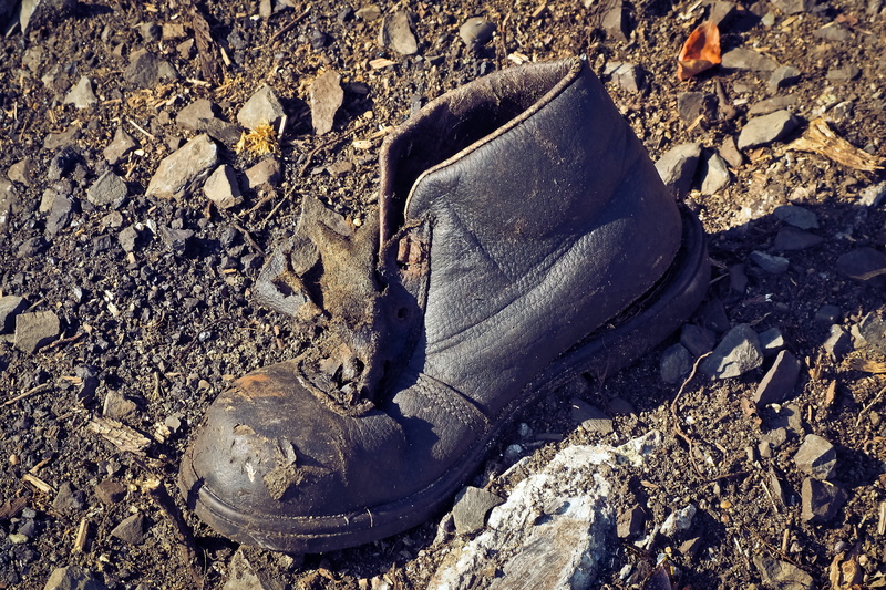 garbage, land, shoe, broken, tooth of time, rock - object, break up, dirt, no people, pollution, transience, ailing, past, black, solid, old, lapsed, leather