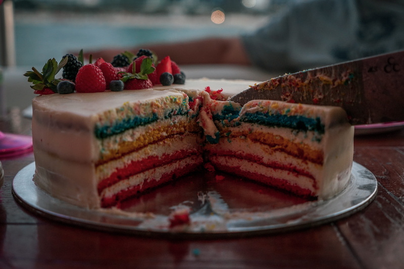 berry fruit, food and drink, dubai, dessert, slice of cake, icing, plate, sweet, french food, crockery, creme, sweet food, person, baked, fruitcake, sweets