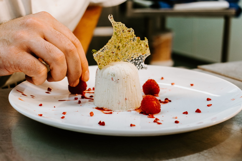 person, dessert, midsection, indoors, freshness, 5K, chef, cake, raspberry, plant, restaurant, gourmet, focus on foreground, ready-to-eat, icing, baked