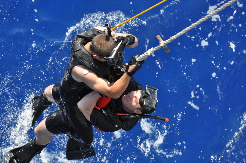 motion, help, blue, training, outdoors, real people, cold temperature, winter, warm clothing, nature, sport, aquatic sport, helicopter, water, swimmer