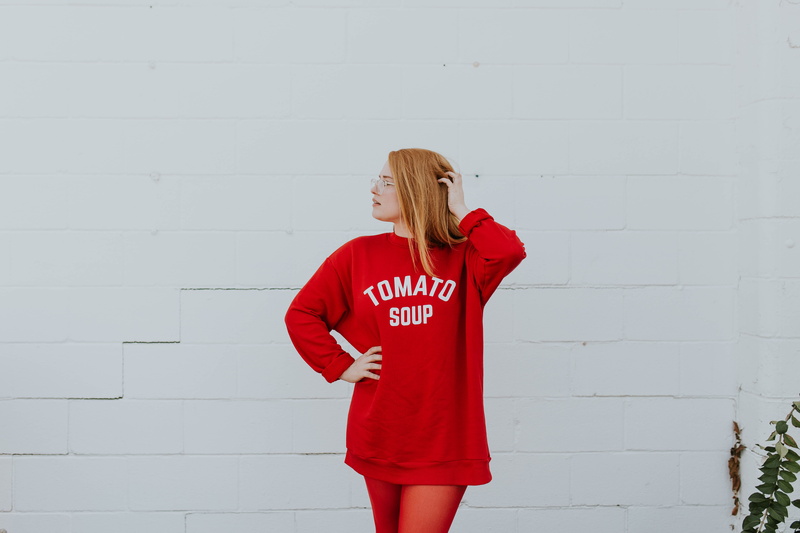casual clothing, pose, leggings, text, one young woman only, winter, people, lady, shirt, wall - building feature, picture, hairstyle, communication, day