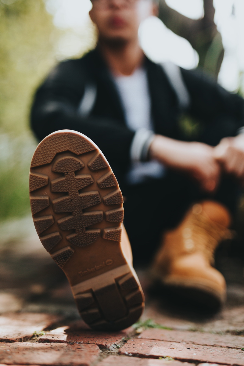 one person, man, close-up, jacket, focus on foreground, shoe, bokeh, pavement, concrete, real people, males, adult, business, lifestyles, boot, selective focus