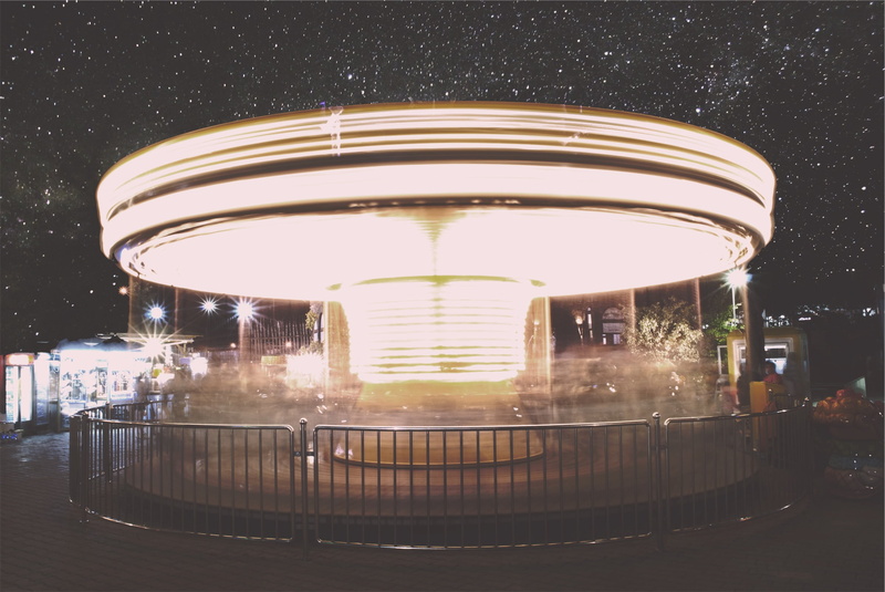 ride, railing, carousel, stars, built structure, beside, fun, fence, nighttime, merry-go-round, sky, architecture, motion, long exposure, illuminated, time