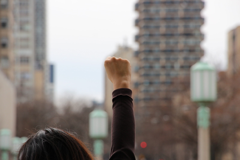female, protest, rear view, lifestyles, human limb, hand, chicago, blurred, skyscraper, outdoors, hairstyle, urban, body part, focus on foreground, headshot