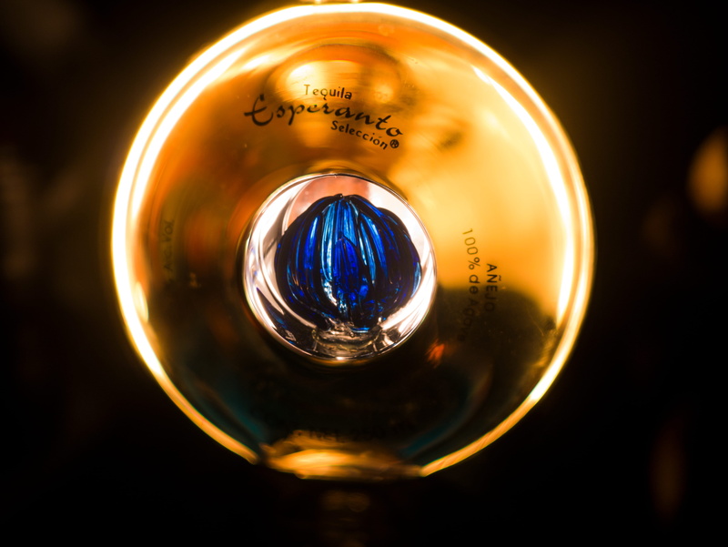 4K, light, close-up, filament, lighting equipment, circle, tequila, bottle, gold colored, studio shot, indoors, single object, blue, shape, black background