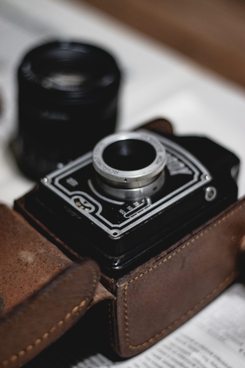 indoors, cookie, table, lens cap, strap, leather, cassette player, keyboard, technology, antique, arts culture and entertainment, spoke, lens - optical instrument
