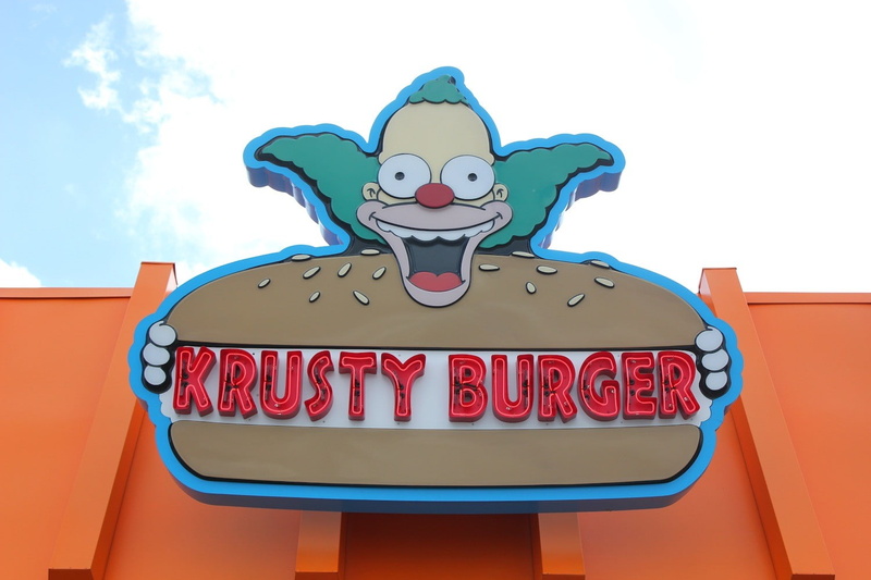 day, outdoors, The Simpsons, low angle view, architecture, nature, text, human representation, sky, food and drink, representation, western script, 720P
