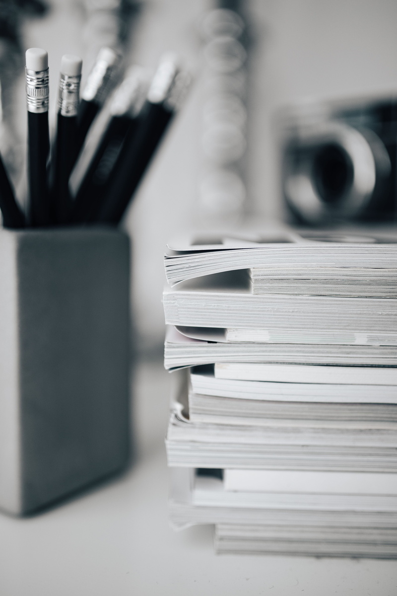 office, magazines, large group of objects, table, education, expertise, design, book, camera, blackandwhite, focus on foreground, close-up, paperwork, group of Objects