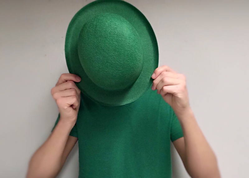 irish, obscured face, front view, hiding, human face, portrait, waist up, green color, white background, child, hat, shirt, childhood, covering, person