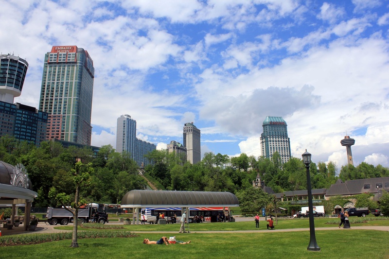 building, outdoors, real people, town, grass, cloud - sky, niagara falls, tall - high, cityscape, building exterior, leisure activity, canada, crowd, city