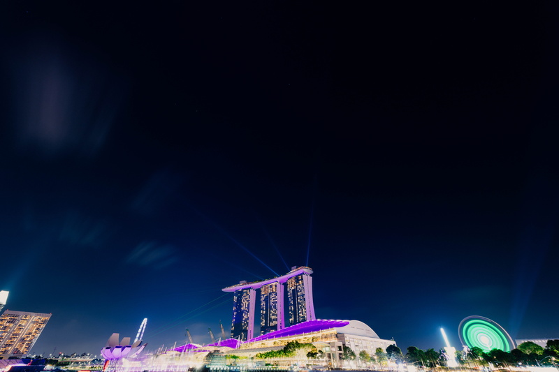 low angle view, concrete, ferris wheel, building exterior, illuminated, multi colored, blue, purple, crowd, outdoors, computer backgrounds, backgrounds