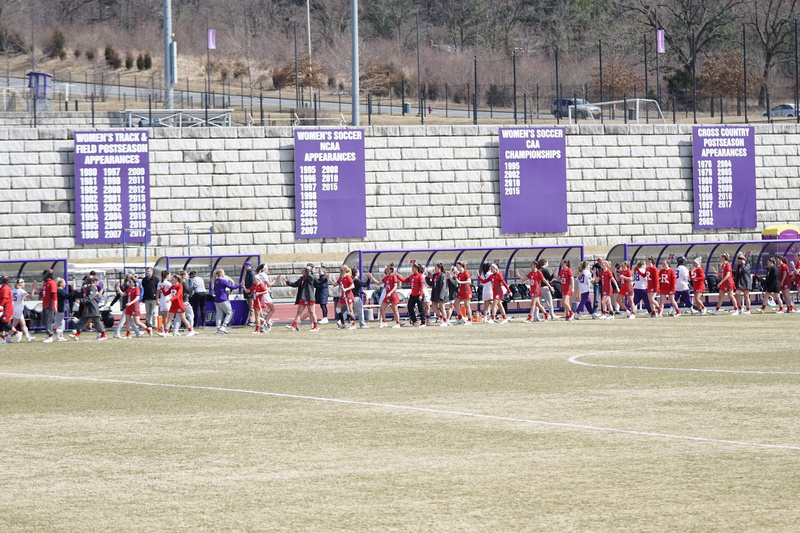 outdoors, person, human, people, government, building, sports clothing, day, sports, football field, furniture, athlete, stadium, soccer team, grass, 5K