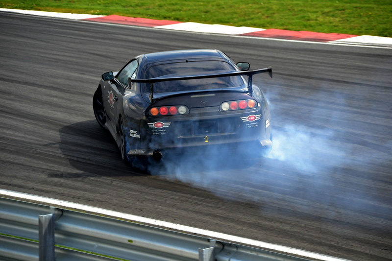 professional sport, motion, Toyota Supra, sign, motor racing track, vehicle, speed, land vehicle, road, race cars, sport, blurred motion, smoke - physical structure