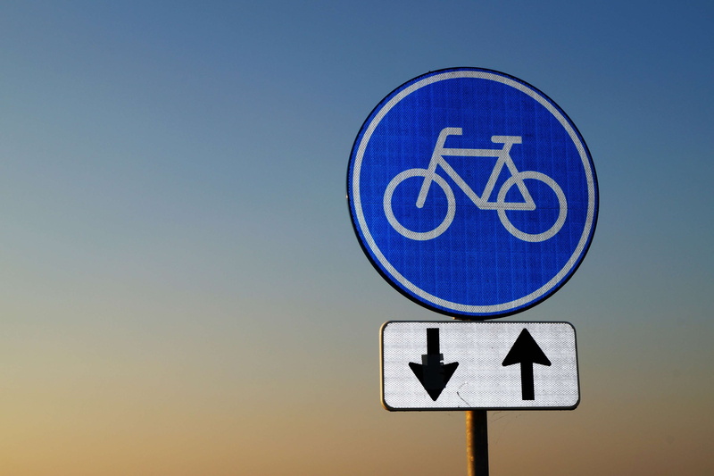 road sign, travel, no people, sunset, option, traffic arrow sign, sun, outdoors, sky, shape, facts, close-up, information, circle, sign, text, illustration