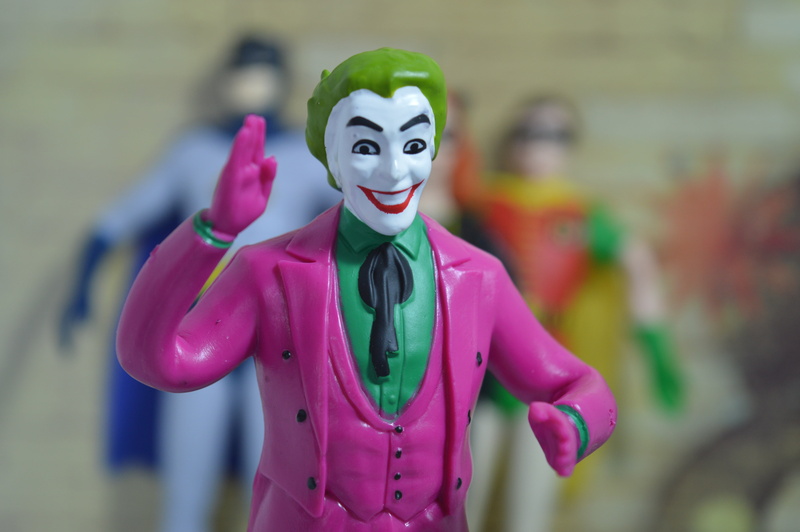 figurine, smiling, focus on foreground, mask, character, superhero, hairstyle, action, disguise, villain, standing, men, celebration, one person, 5K, front view