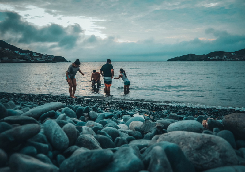 coast, playing, peru, solid, four, person, sky, beach, 4K, scenics - nature, cloud - sky, body, group of people, rock - object, cobblestone, women, play