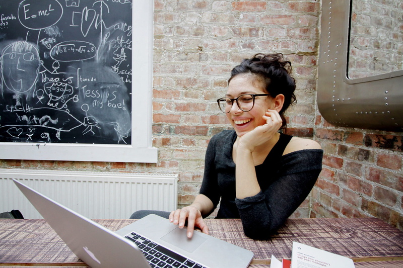 communication, wearing, computer, black, real people, adult, waist up, wireless technology, seating, women, brick wall, compuer, wile, connection, business