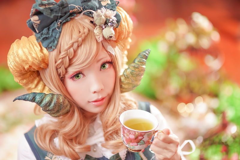 drinking, beautiful woman, outdoors, focus on foreground, close-up, hair, green eyes, looking at camera, cup, horns, leisure activity, one person, portrait