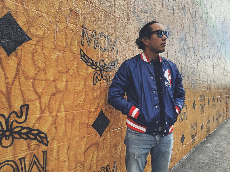 sunglasses, clothing, three quarter length, wall, jacket, front view, real people, graffiti, leisure activity, man, denim, wall - building feature, accessories