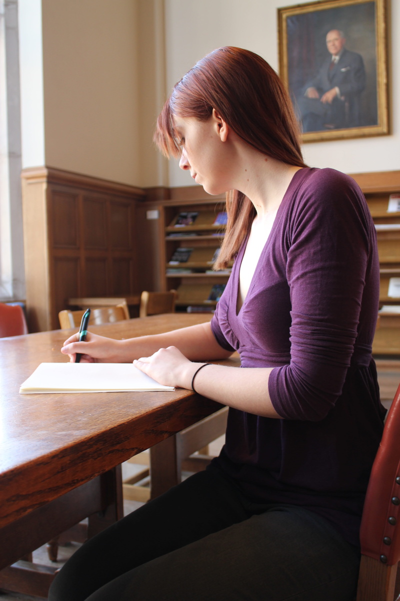 writing, table, young adult, v, purple, casual clothing, shirt, student, one person, learn, three quarter length, one woman only, hair, females, wearing