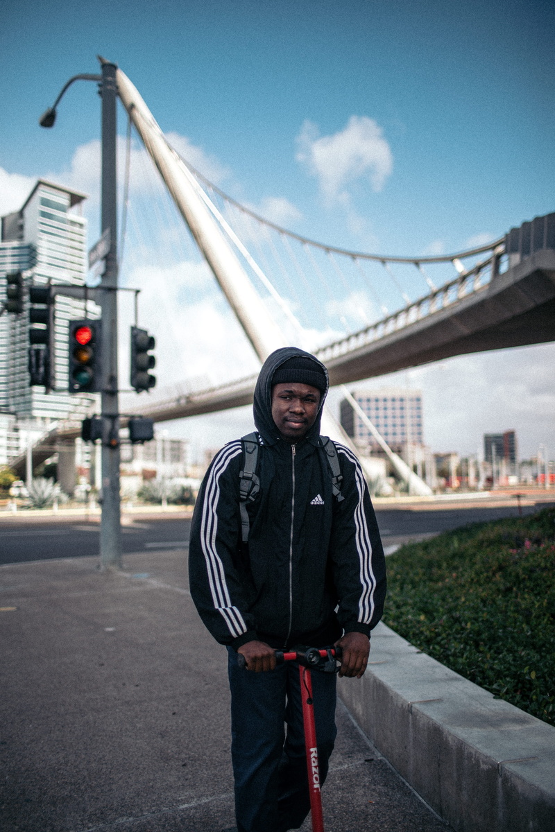 day, wearing, casual clothing, front view, plaid, architecture, apparel, adidas, white, light, kilt, jacket, built structure, coat, standing, leisure activity