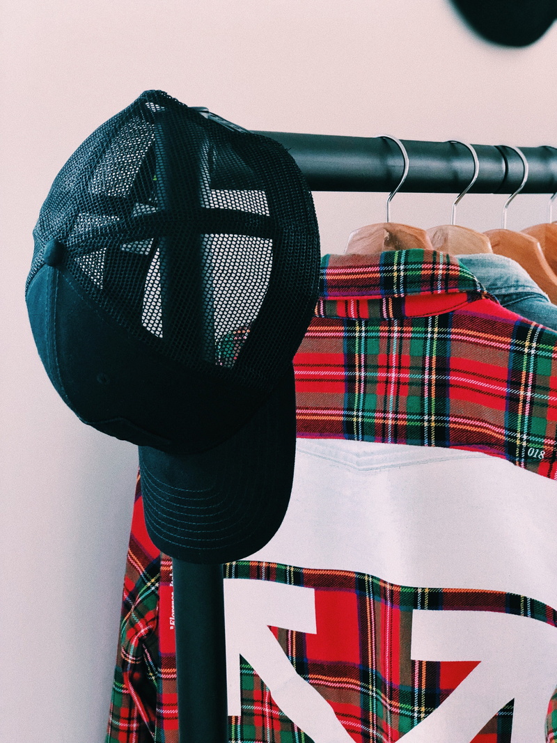 sweater, cap, furniture, absence, outdoors, mesh, textile, arts culture and entertainment, clothes, off-white, overcoat, day, shop, multi colored, tartan