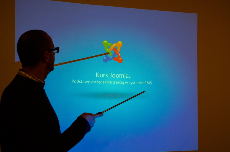 gesturing, pointing, headshot, profile view, touch screen, analyzing, cms, course, colored background, lecture, science, studio shot, holding, standing