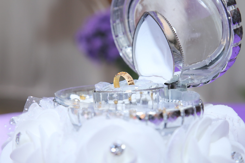 selective focus, glass, indoors, close-up, ring, jewelry, life events, plant, table, flower, still life, transparent, purple, silver colored, display, wedding