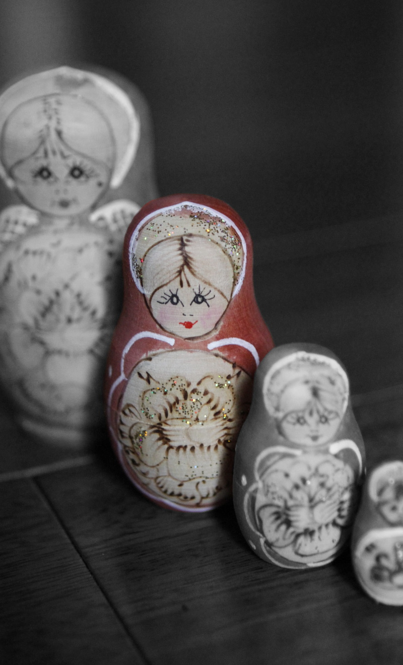 floral pattern, difference, inherit, medium group of objects, human representation, ornate, focus on foreground, black background, russian dolls, heritage