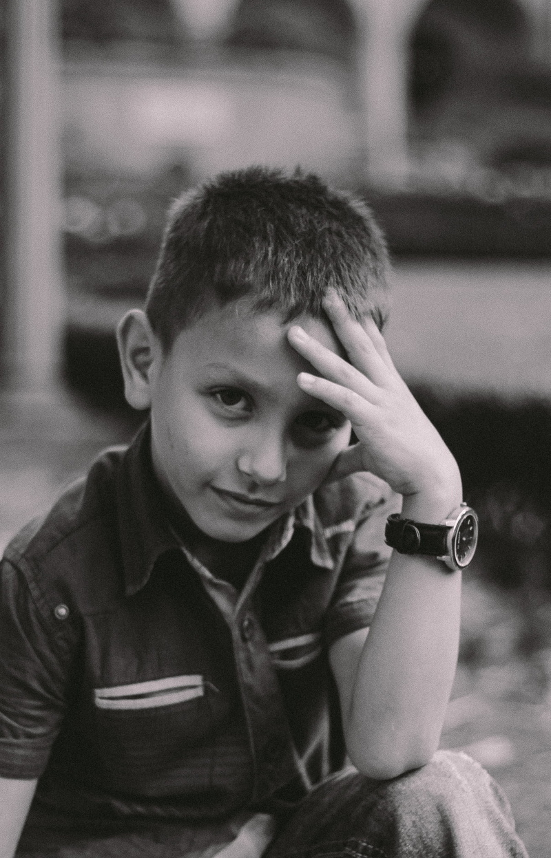 lifestyles, sitting, portrait, innocence, indoors, monochrome, smiling, model, men, looking at camera, grief, watch, person, fingers, hand, happiness, boy