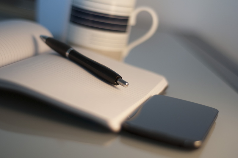 furniture, fountain pen, organization, retractable, table, still life, mug, indoors, business, white, communication, coffee, work, pen, desk, ruled, note pad