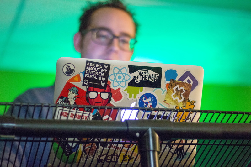 sticker, gray, indoors, farm, glasses, males, men, silver, green color, 5K, shelf, one person, laptop, eyeglasses, lifestyles, front view, headshot, finance