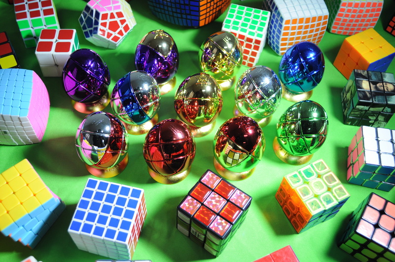 indoors, side by side, table, celebration, no people, high angle view, multi colored, close-up, rubik, leisure games, decoration, puzzle, variation, choice