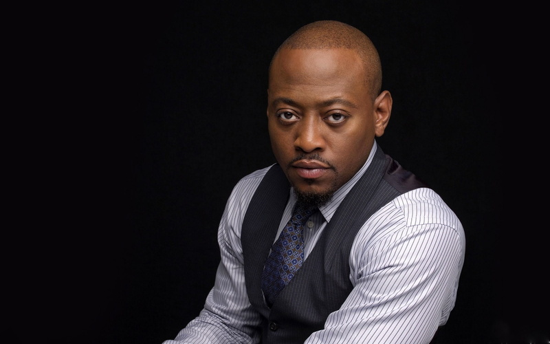 front view, business, shaved head, black background, clothing, suit, well-dressed, one person, confidence, portrait, men, 1080P, headshot, looking at camera