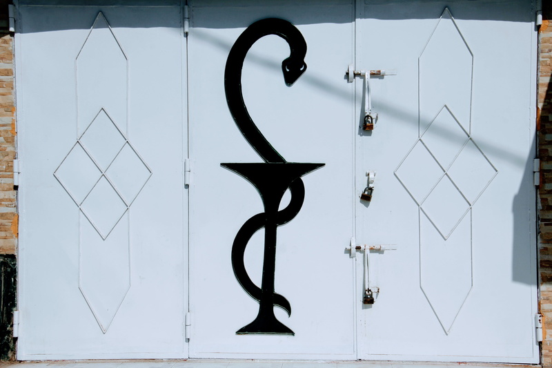 wall - building feature, dollar sign, indoors, built structure, closed, number, business, no people, simplicity, metal, pharmacist sign, architecture, pharmacy