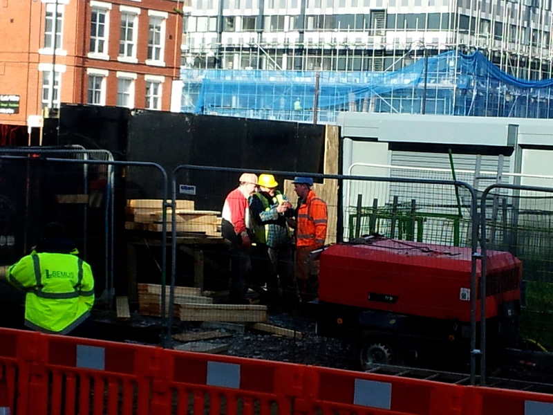 outdoors, construction industry, real people, group of people, built structure, development, city, protective workwear, transportation, construction worker