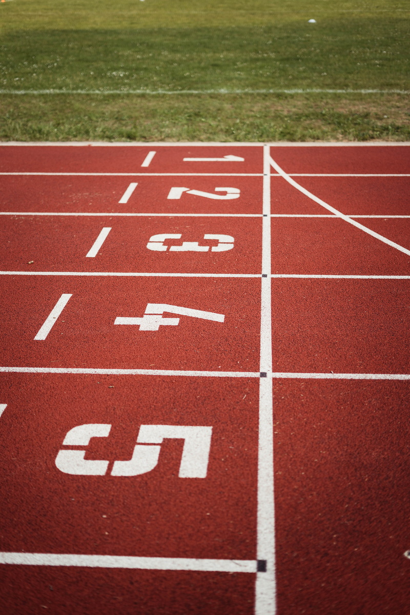 oval, text, track event, competition, field, sport, no people, start, red, competitive sport, running track, line, 5K, sports track, stadium, playing field